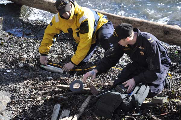 Divers clear washed up ordnance from beach