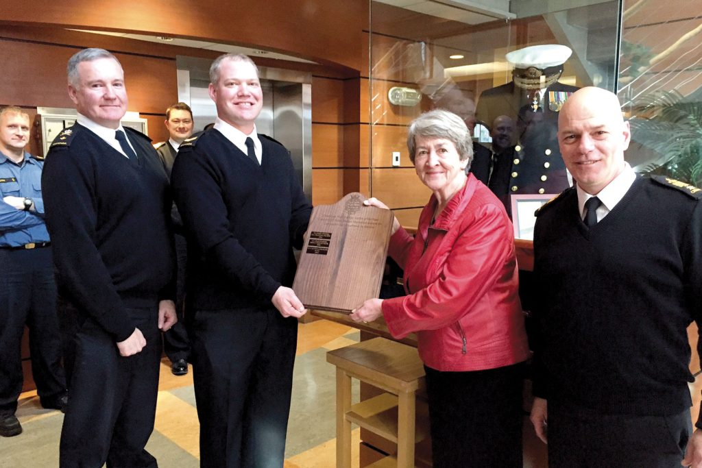 LS Calvin Langager (second from left) accepts the Sailor of the Year plaque from Geraldine Hinton while Cmdre Zwick (left)