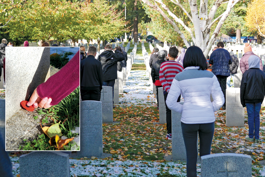 Students place poppies at God’s Acre graves
