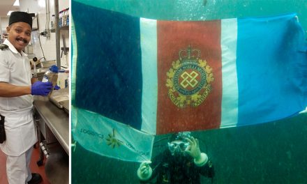 Army cook takes ocean dip with Logistics flag