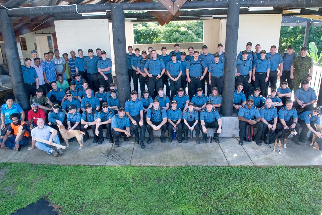 Over 60 volunteers from the ship’s company gather for a photo at the Homes for Hope campus