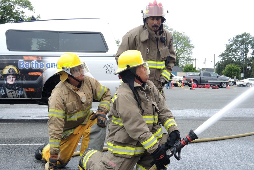 Members of the B.C. First Nations Services Society (FNESS) work to perform an exterior attack on a live fire simulator (not pictured) on June 4 at the Archie Browning Sports Centre. Photos by LS Alex Ilareguy