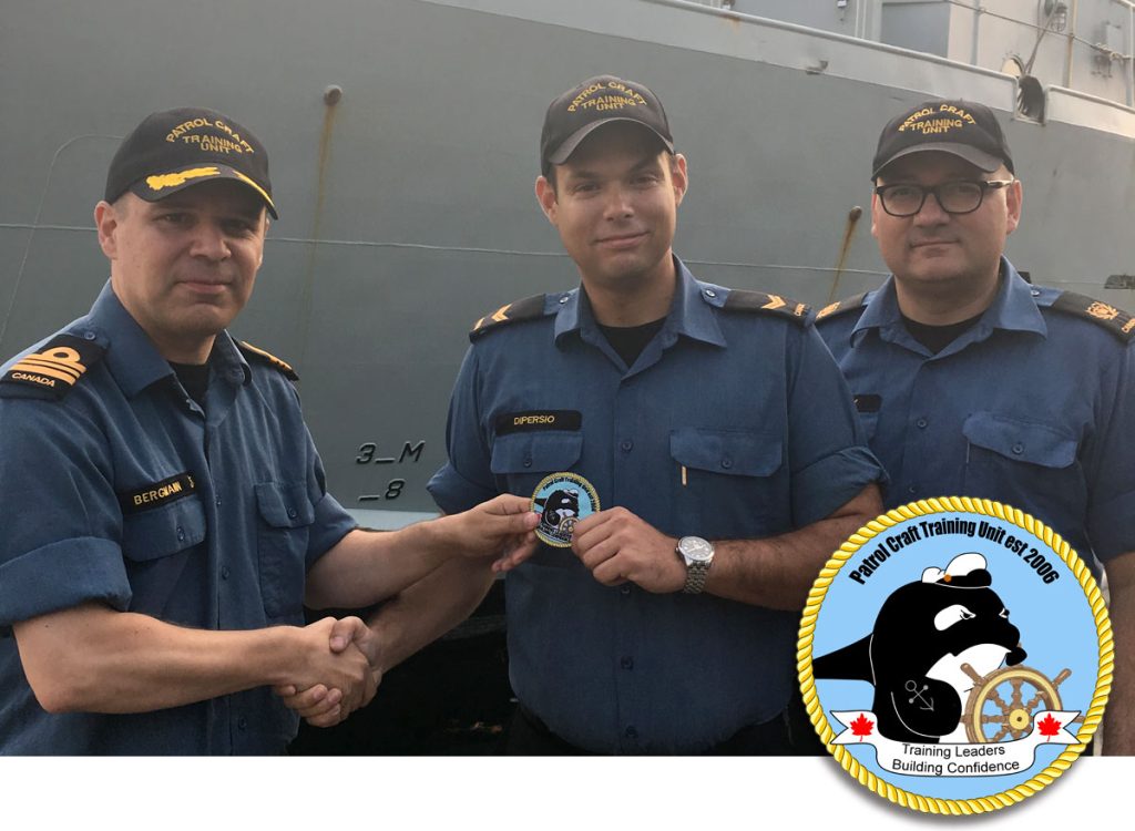 LS Nicholas Dipersio (centre) presents the unit’s new morale patch that he designed to LCdr Tyson Bergmann