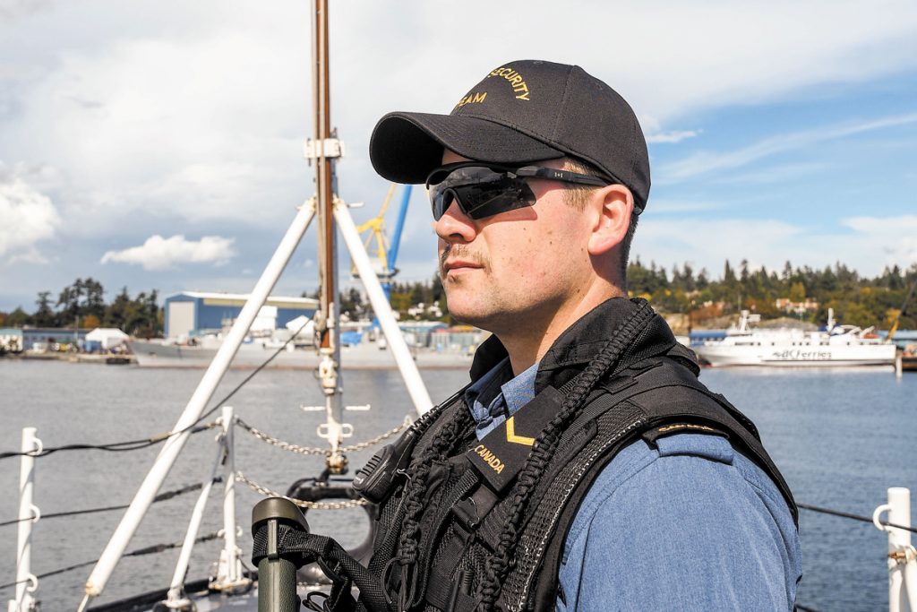 AB Darcey Tieincy on watch as upper deck sentry aboard HMCS Vancouver during the sea training validation phase prior to deployment. Photos by SLt M.X. Déry