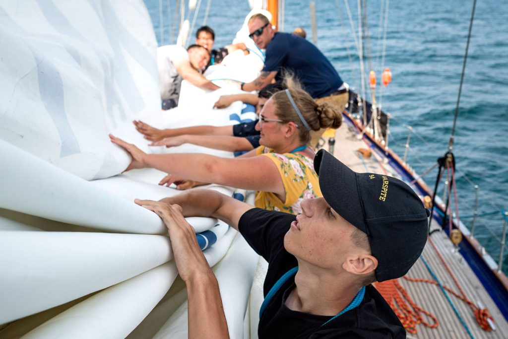 Cadet Jordan Bechard works diligently at flaking the mainsail aboard the training vessel HMCS Oriole while sailing on Lake Ontario during the 2018 Great Lakes Deployment. Photos by MCpl Neil Clarkson