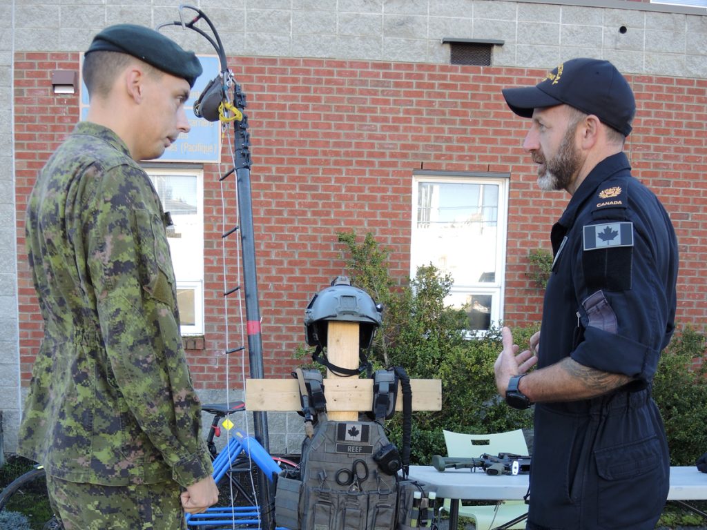 Corporal Ryan Cunningham of Base Logistics speaks with a member of the Naval Tactical Operations Group during the Canada Defence Team Career Networking Fair on Oct. 17. CFB Esquimalt was one of seven military bases across Canada to participate in the first annual career networking fair. Photo by Peter Mallett