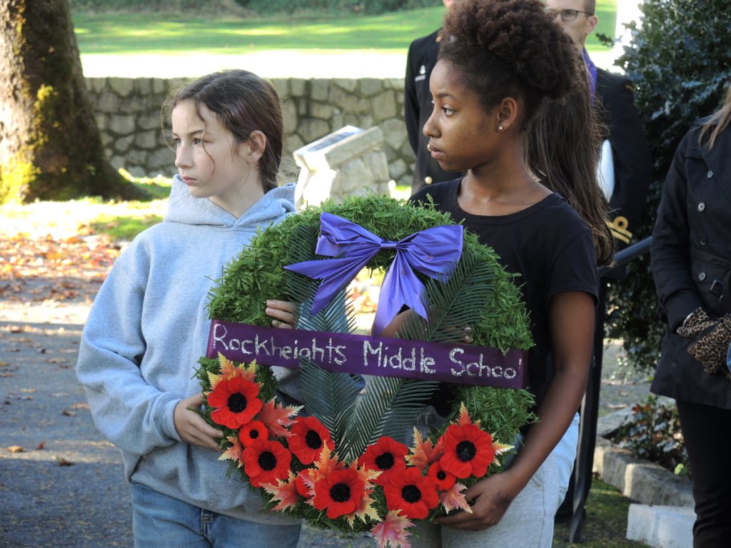 Wreath bearers from Rockheights Middle School take part in a moment of silence. Photo by Peter Mallett