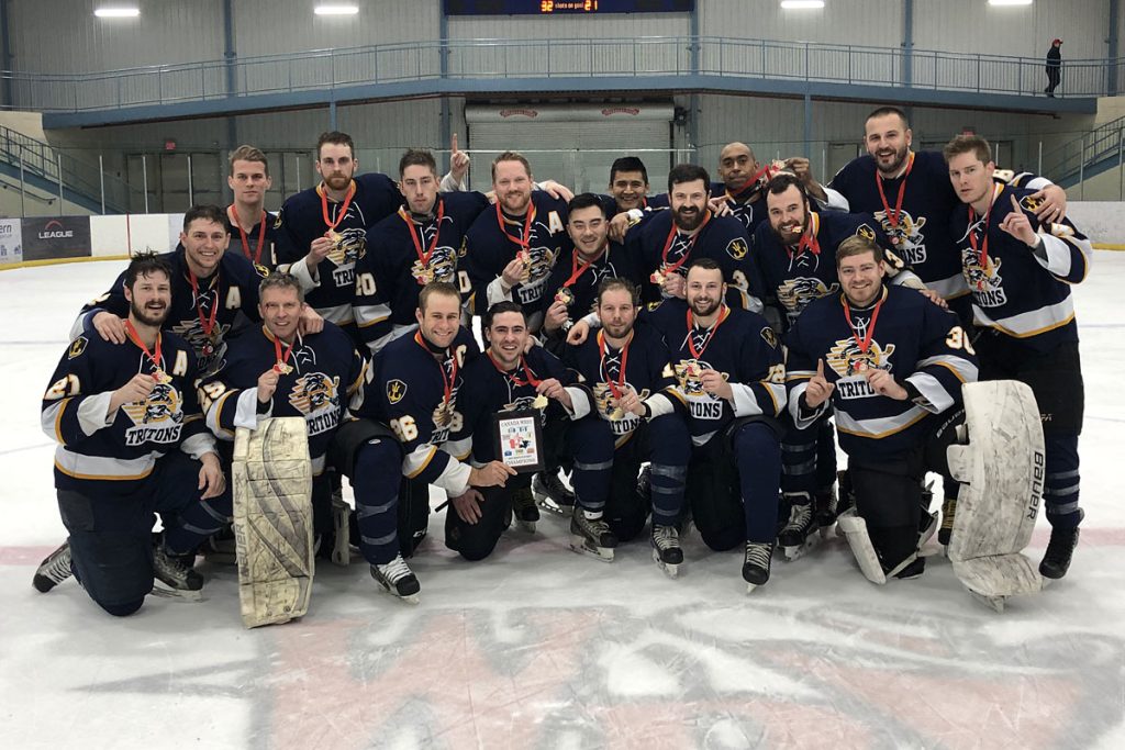 Members of the CFB Esquimalt Tritons gather for a victory photograph following their 5-4 win over CFB Edmonton in the championship game of the Canada West Regional hockey tournament in Wainwright