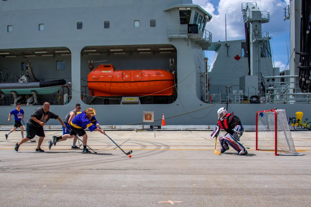 Members of the HMCS Regina and NRU Asterix’s crews play a game of ball hockey during some down time during Operation Projecton on Naval Base Guam in Guam