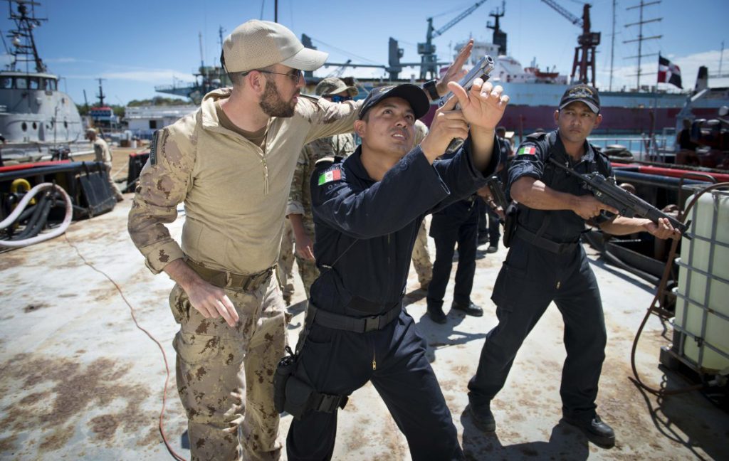 A member of the Canadian Naval Tactical Operations Group teaches Mexican Navy personnel techniques on how to secure the perimeter of a ship at the Las Calderas Naval Station in Dominican Republic. Photo by Private Tori Lake