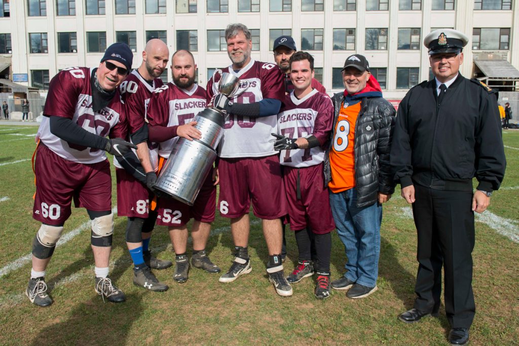 Members of the Fleet Club Slackers celebrate their 20-14 Mini Grey Cup victory along with RAdm Craig Baines