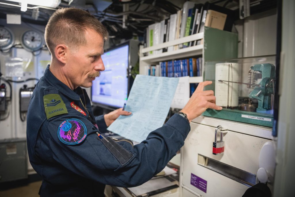 Meteorologist MCpl Dan Jacklin monitors special equipment to help him prepare a weather forecast on board HMCS Ottawa. Photo by Leading Seaman Victoria Ioganov