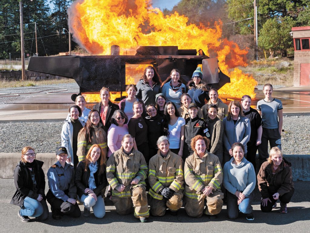 Guests of the DWAO pose for group photo in front of the outside fire trainer.  Photos by Leading Seaman Brendan Gibson