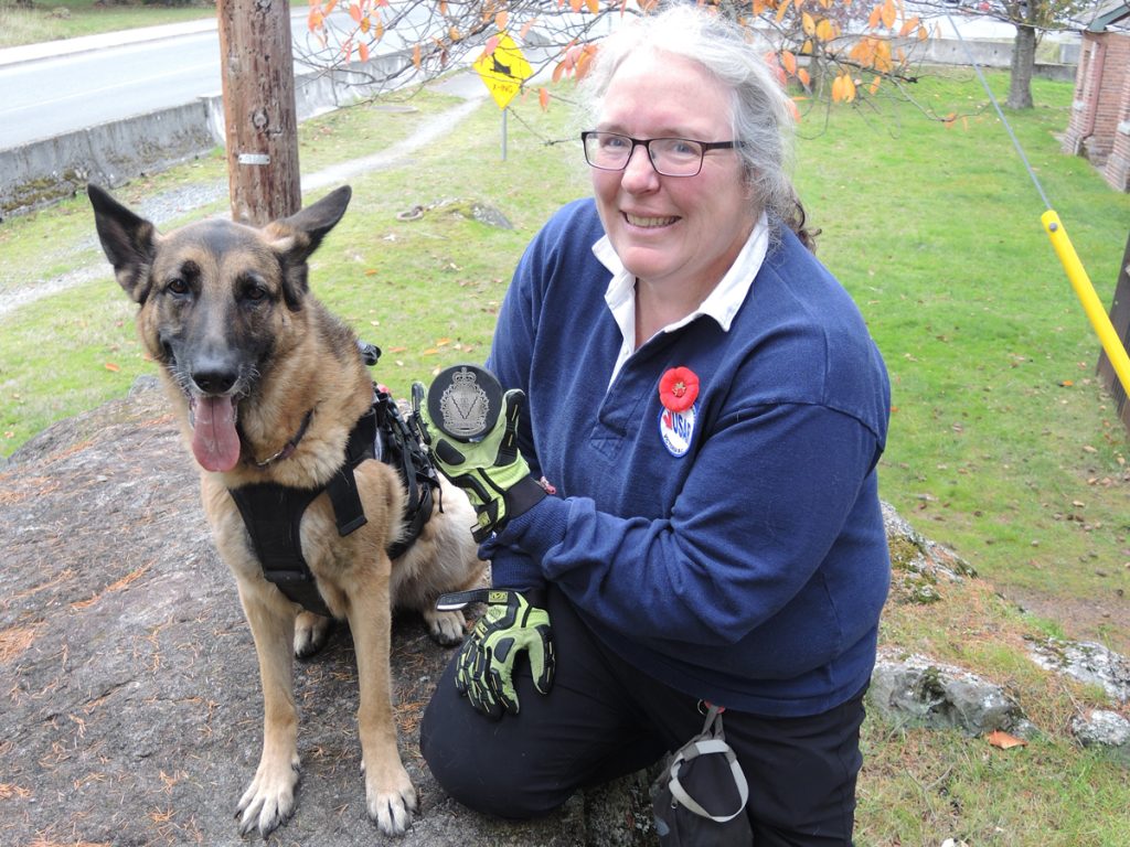 Nine-year-old German Shepard Miss Moxxii and her handler Angela Lavergne show off the special commemorative puck they will use in the ceremonial opening puck drop for the Victoria Royals Defence Appreciation Night at the Save On Foods Memorial Centre on Nov. 15.  Photo by Peter Mallett/Lookout