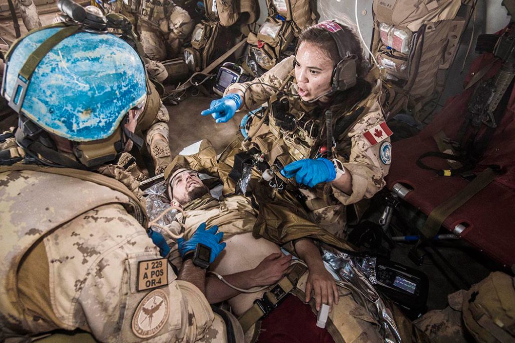 A female member of Task Force-Mali’s Canadian Medical Emergency Response Team provides direction during a forward aeromedical evacuation exercise aboard a CH-147F Chinook helicopter in March. Photo by Corporal François Charest