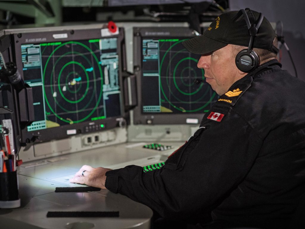 PO2 Sebastien St-Pierre monitors the Senior Sonar Operator Console aboard HMCS Ottawa. Photo by LS Victoria Ioganov