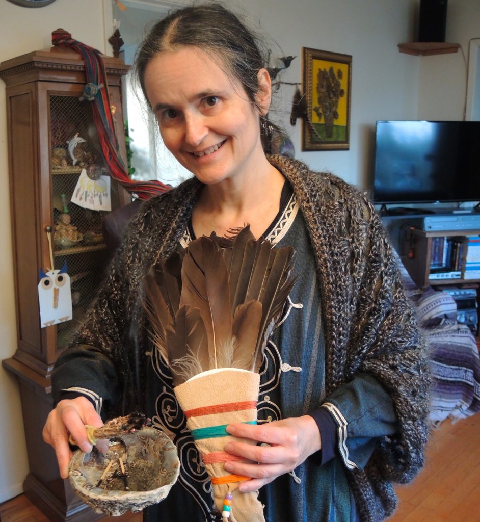 Petty Officer Second Class Marielle Audet performs a smudging ceremony using a variety of herbs and grasses grown at her home garden in Colwood. She grows the herbs to help supply smudging kits for vessels of the Royal Canadian Navy.  Photo by Peter Mallett