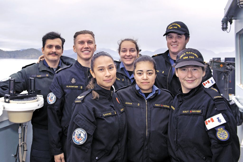 Members of the Sunday service group pose on the bridge wing of HMCS Nanaimo as the ship transits off the coast of Vancouver Island. Left to Right: LS Ramsin Zaro