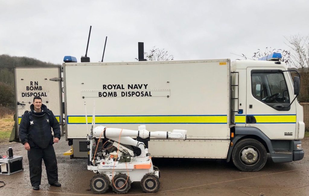 Lt(N) Kevin Okihiro with a bomb disposal robot.