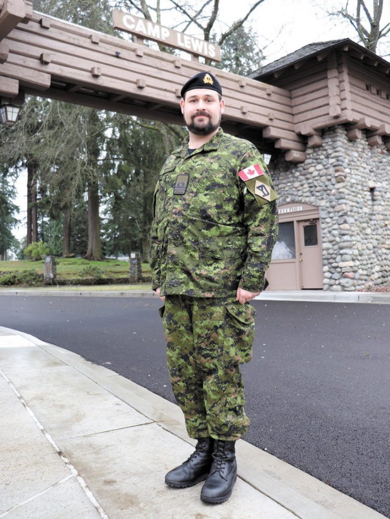 Naval reservist Lieutenant (Navy) Joseph Kinley at the main gate of Joint Base Lewis-McChord after completing Warfighter Exercise 20-3 Feb. 13