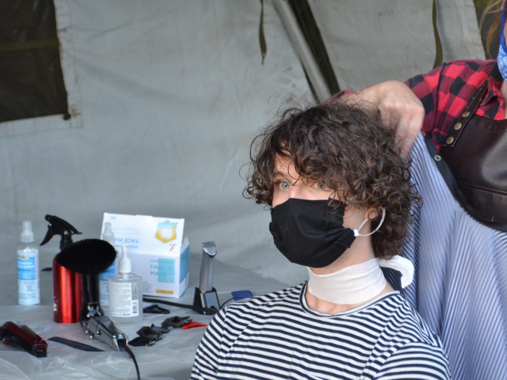 In a makeshift tented barber shop in Work Point