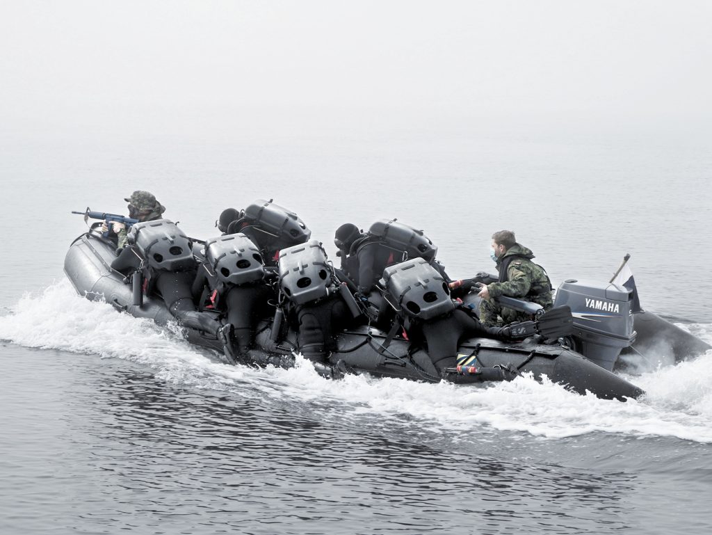 Clearance Divers in-training practice covert insertion into an enemy held beachfront to search for sea mines.