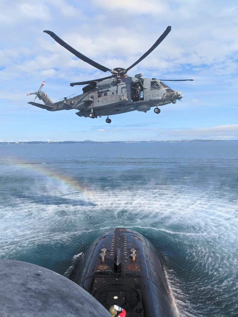A CH-148 Cyclone helicopter conducts a training exercise with HMCS Victoria on Sept. 22. The submarine commenced sea trials on Sept. 18