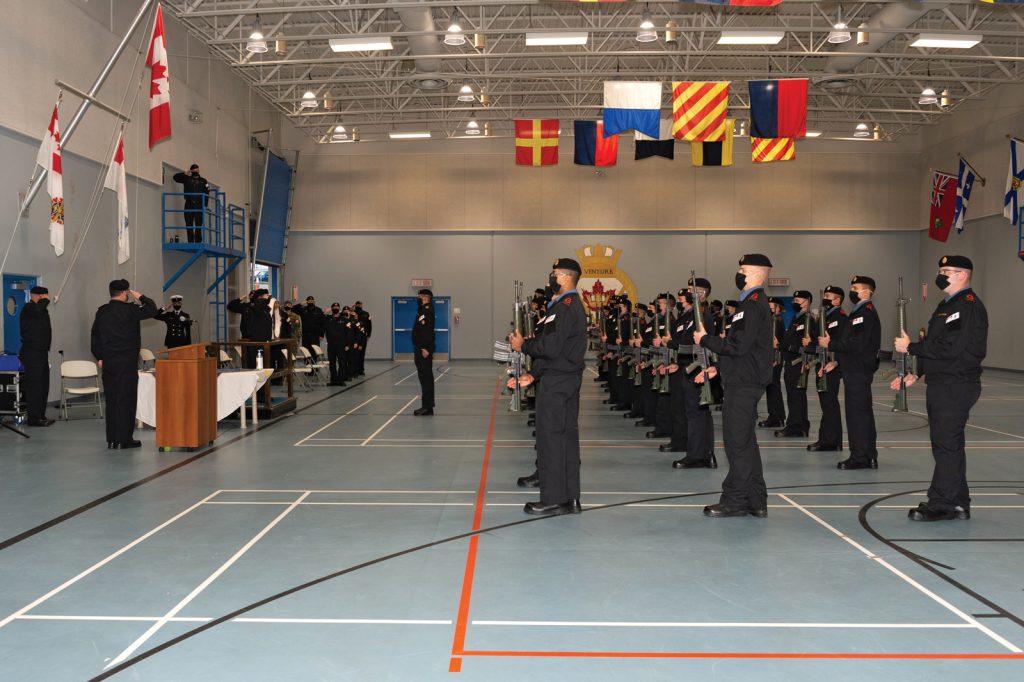 Graduates of Basic Military Qualification R0236E present arms during their Graduation Ceremony at the Nixon Gym in Work Point on Oct. 23. Photo by S1 Sisi Xu
