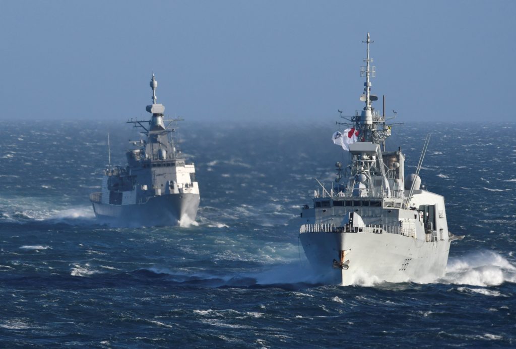 HMCS Calgary (left) and HMNZS Te Kaha (right) conduct a sail past Esquimalt Lagoon as Te Kaha heads back to New Zealand after spending 18 months in Esquimalt completing an extensive upgrade and refit program.