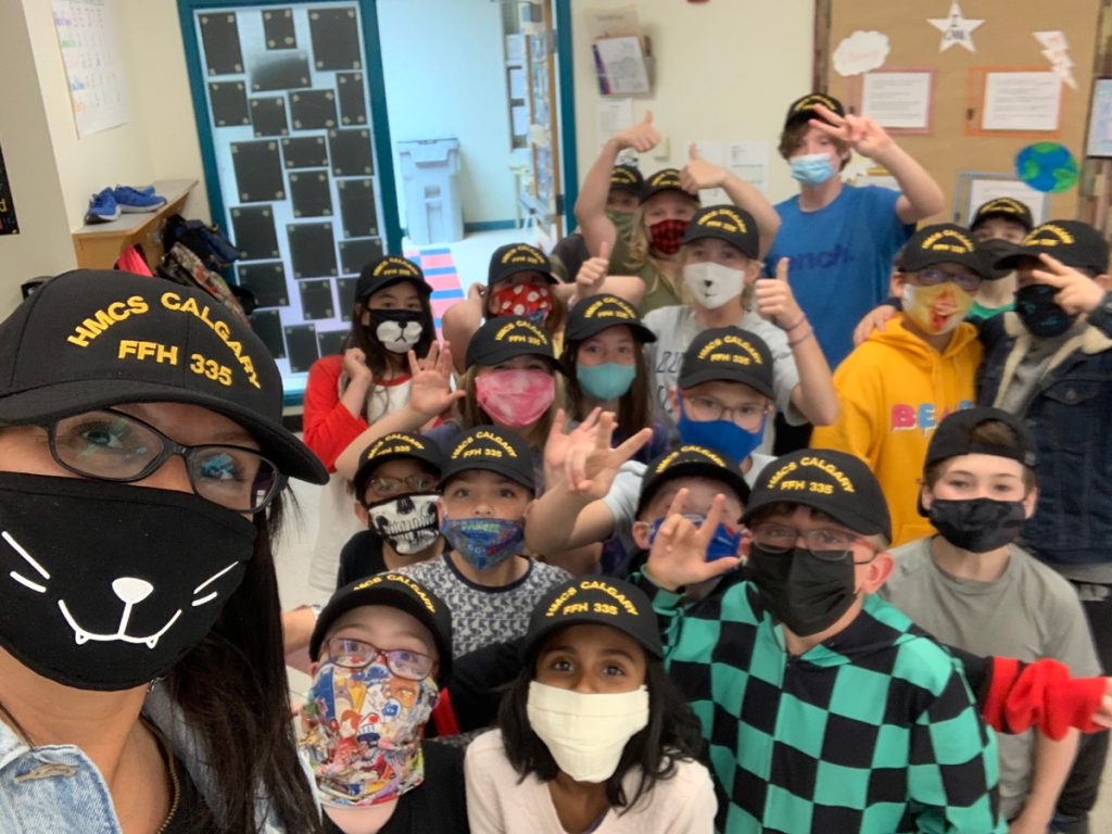 Carol Stapleton’s Grade 5 class at Fish Creek School in Calgary pose for a photo after receiving hats from HMCS Calgary’s Petty Officer Second Class Joseph Chisling