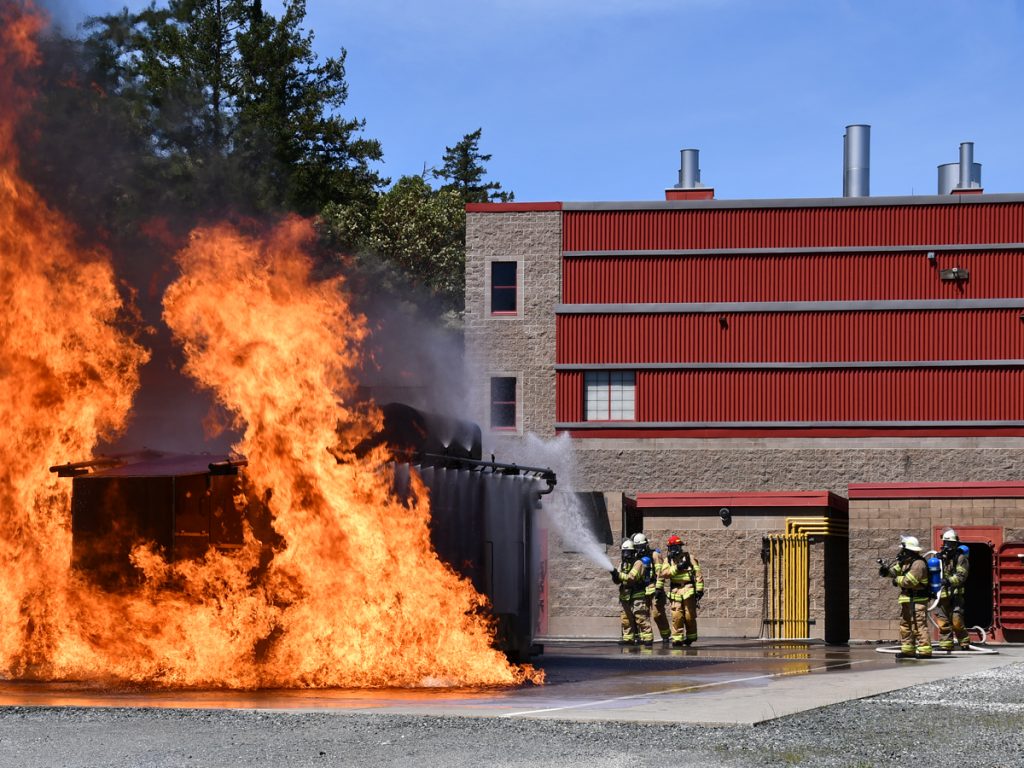 Naval Fleet School (Pacific) trains for helicopter crash rescue with Damage Control Division.