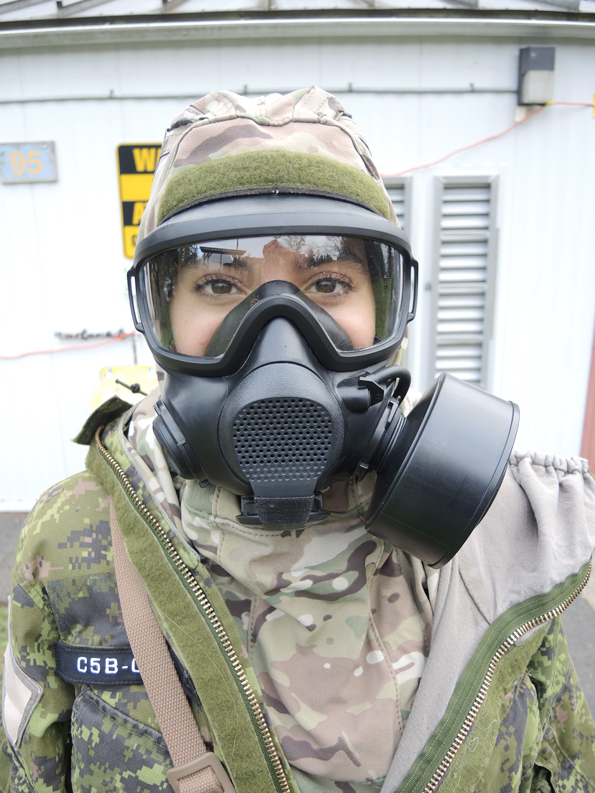 Trial participant Corporal Quian Meftah of 35 Combat Engineer Regiment displays her C5B gas mask outside the gas hut