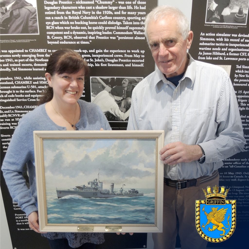 Alan Dennis presents a painting of Royal Navy vessel HMS Griffin to Tatiana Robinson
