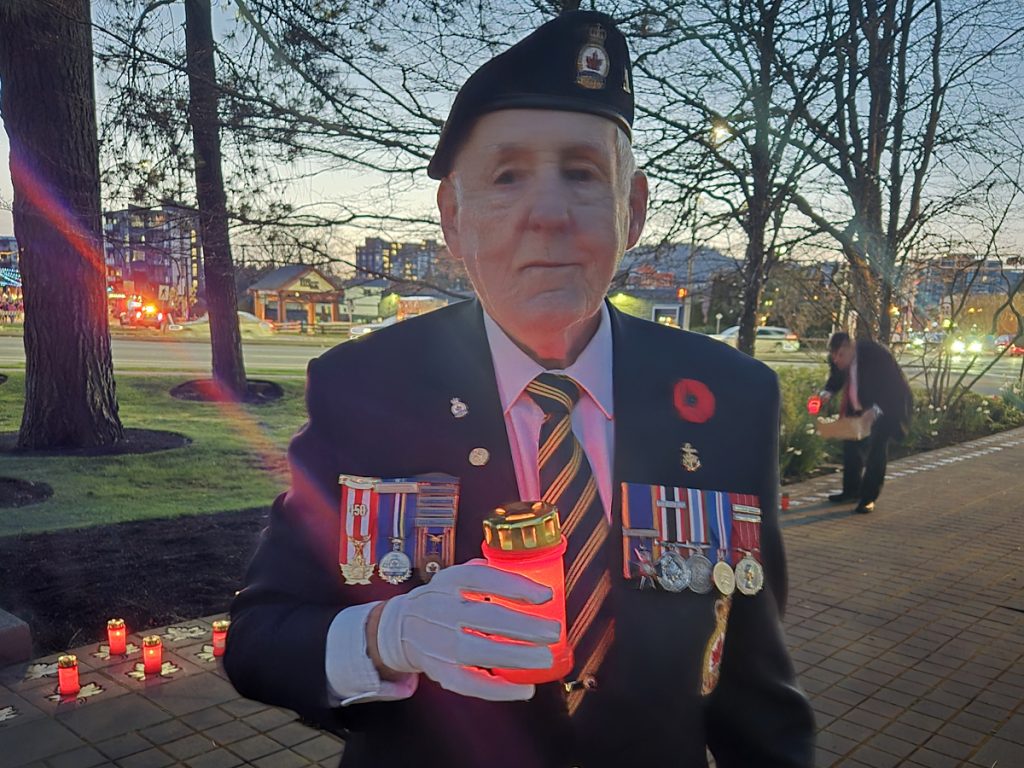 Top: Chief Petty Officer 1st Class (ret’d) John Robert Bourdage holds a candle during a Battle of Vimy Ridge Candlelit Tribute