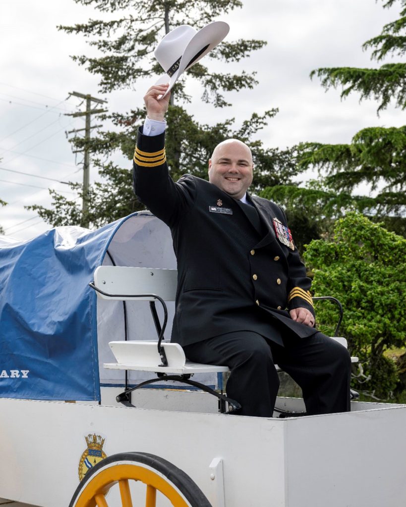 Members of HMCS Calgary row ashore Commander Jeremy Samson (above)
