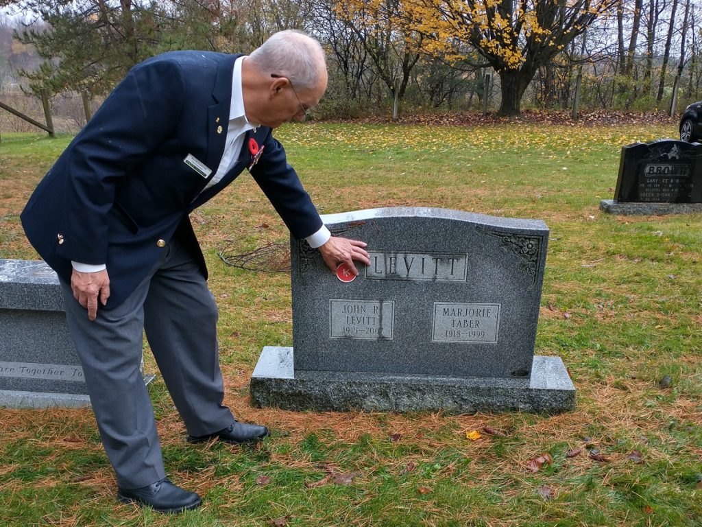 Hong Kong Veterans Commemorative Association volunteer Derrill Henderson points to the “HK” marker being added to gravestones across Canada