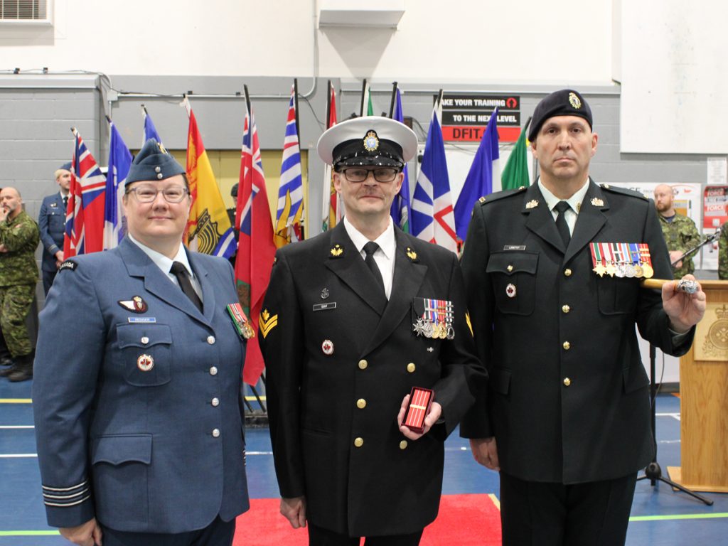 Master Sailor (MS) Guay receiving his Canadian Decoration 3 Clasp. From Left to right: Lieutenant-Colonel L.J. Rediger