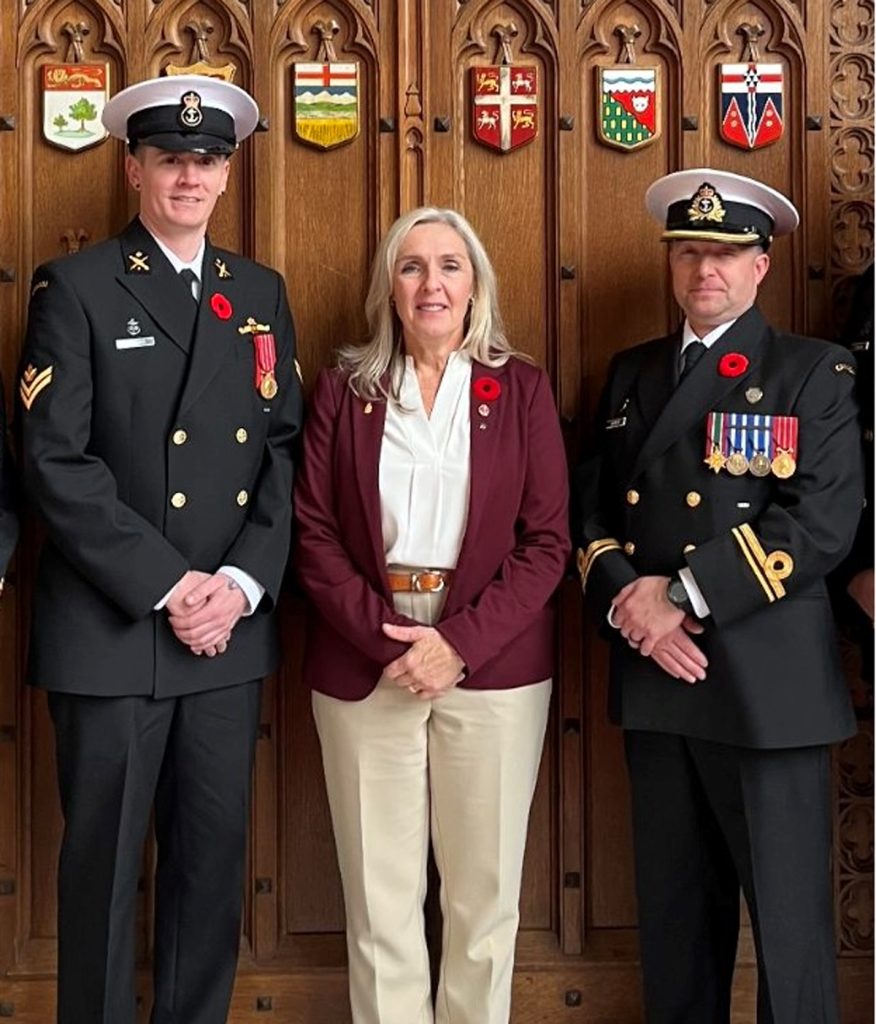 Master Sailor Jeffrey Harding and Sub-Lieutenant Jonathan Robinson stand with Rear-Admiral (Ret’d) Senator Rebecca Patterson in the Senate Chamber in Ottawa